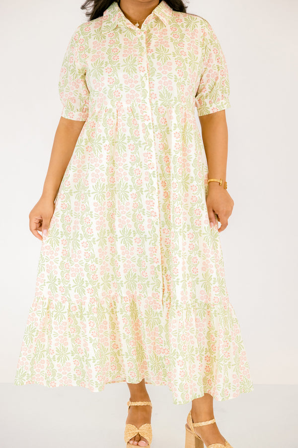 Chic Soul plus size clothing,  pink floral button up maxi dress with short sleeves that have cuffs at each end as well as a collar and a pink and green floral pattern throughout
