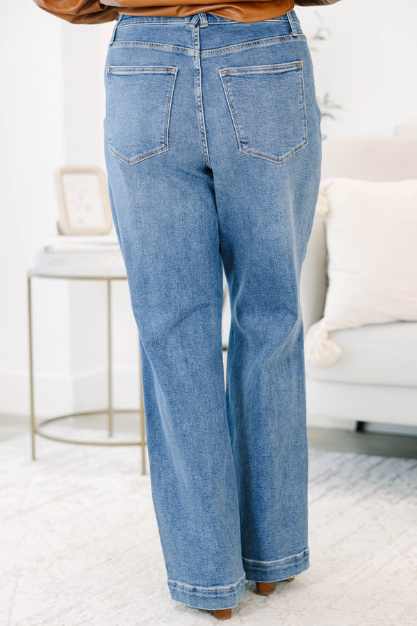 Plus Size medium wash wide leg jeans with star-shaped stitching on the front pockets and seams.