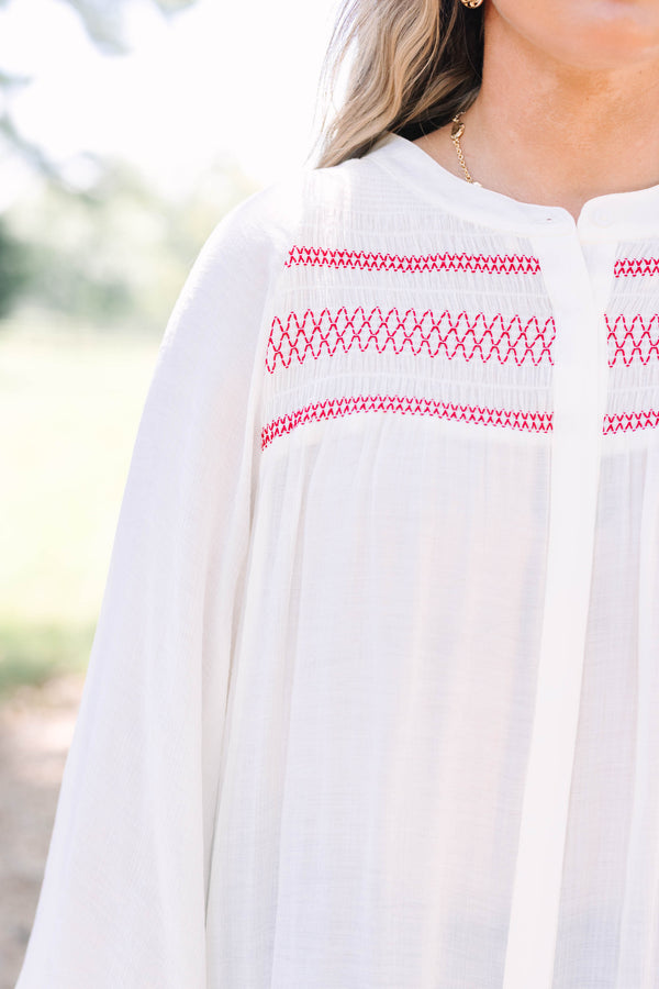 Plus Size cream long-sleeved top with red smocked embroidery on the chest and smocked cuffs.