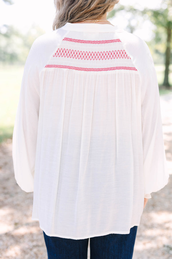 Plus Size cream long-sleeved top with red smocked embroidery on the chest and smocked cuffs.