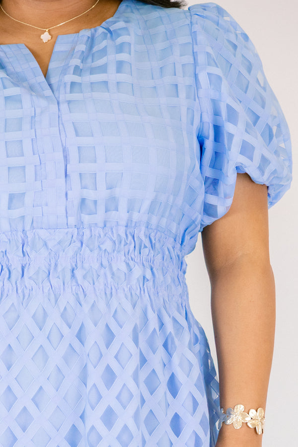 Chic Soul plus size clothing, pastel blue maxi dress with buttons going down to the chest and bubble sleeves as well as a sheer overlay going over the whole dress that has a plaid pattern 