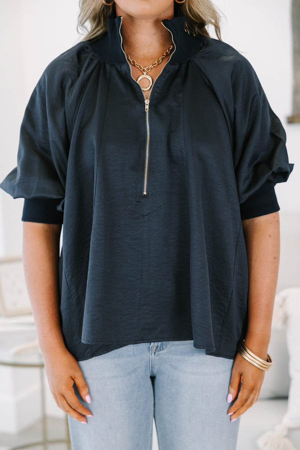 Plus size navy blue half-zip top with a flowy fit, short sleeves, and a gold zipper detail.