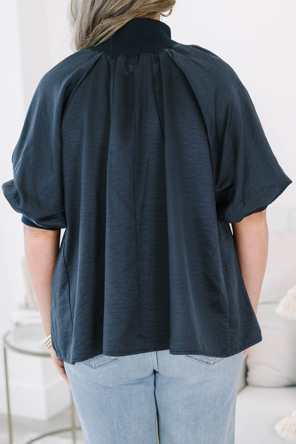 Plus size navy blue half-zip top with a flowy fit, short sleeves, and a gold zipper detail.