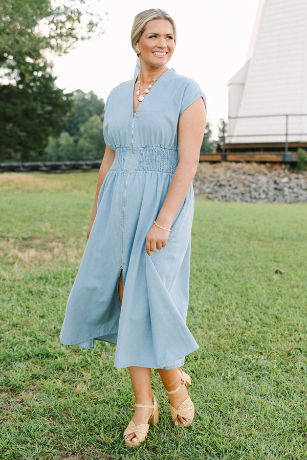 Plus Size light wash denim midi dress with a zip-front, V-neckline, and smocked waist.