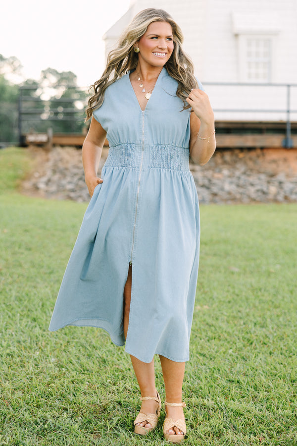 Plus Size light wash denim midi dress with a zip-front, V-neckline, and smocked waist.