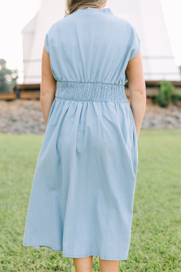 Plus Size light wash denim midi dress with a zip-front, V-neckline, and smocked waist.