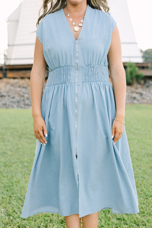 Plus Size light wash denim midi dress with a zip-front, V-neckline, and smocked waist.