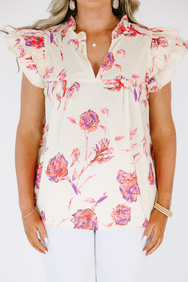 Plus Size cream floral v-neck top with flutter sleeves and a vibrant pink and purple flower print.