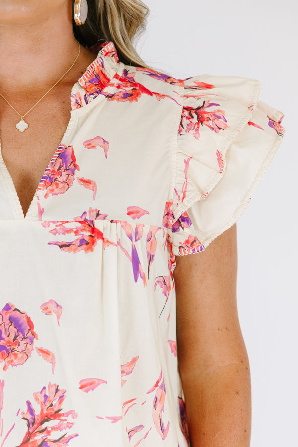 Plus Size cream floral v-neck top with flutter sleeves and a vibrant pink and purple flower print.