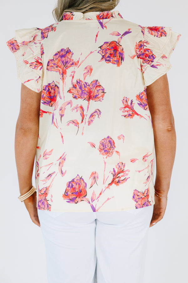 Plus Size cream floral v-neck top with flutter sleeves and a vibrant pink and purple flower print.