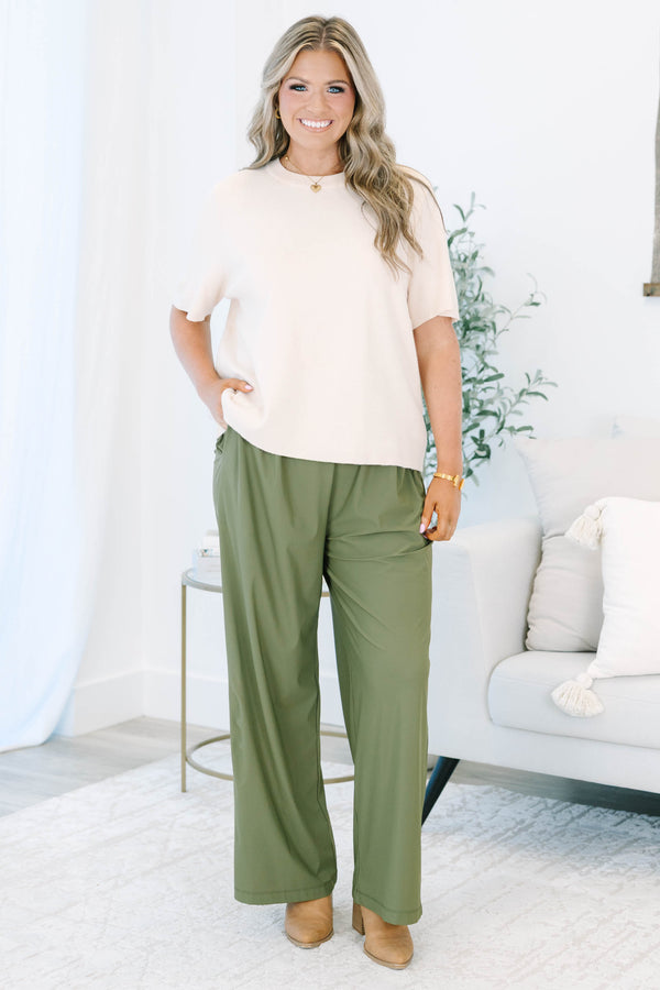 Plus size khaki green wide-leg pants with a flowy fit and stretchy, lightweight fabric.