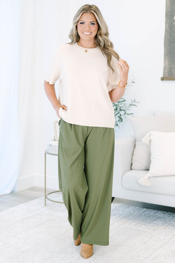 Plus size khaki green wide-leg pants with a flowy fit and stretchy, lightweight fabric.