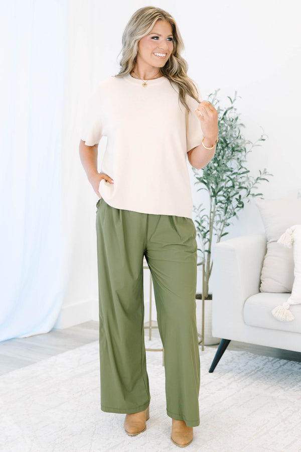 Plus size khaki green wide-leg pants with a flowy fit and stretchy, lightweight fabric.