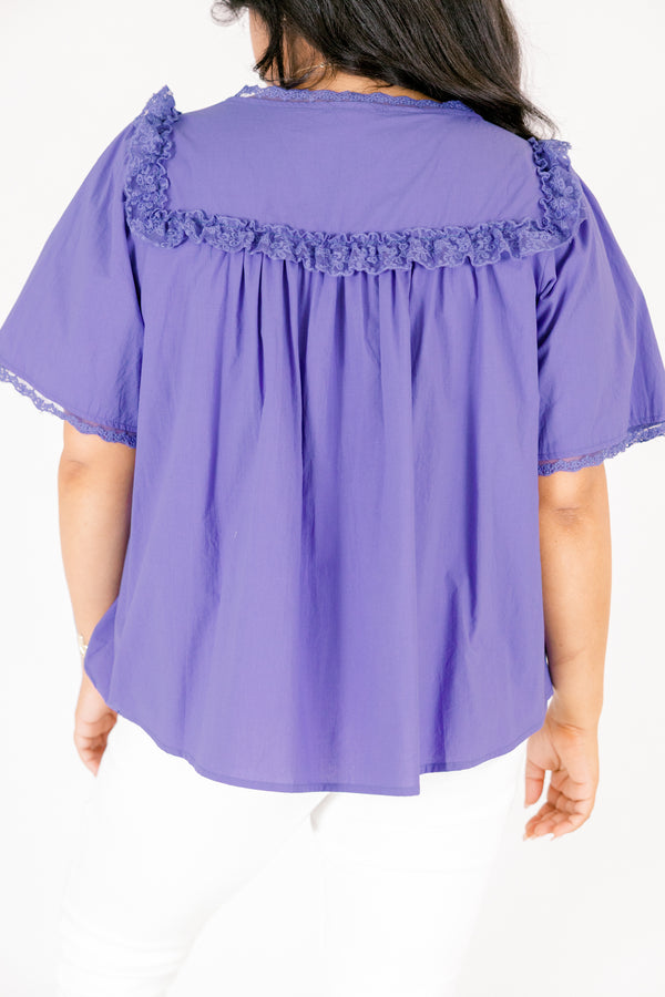 Chic Soul plus size clothing, blue short sleeve top featuring a ruffle bib on the shoulders lace details down the center and lace trim along the ends of each sleeve and the shoulder ruffle