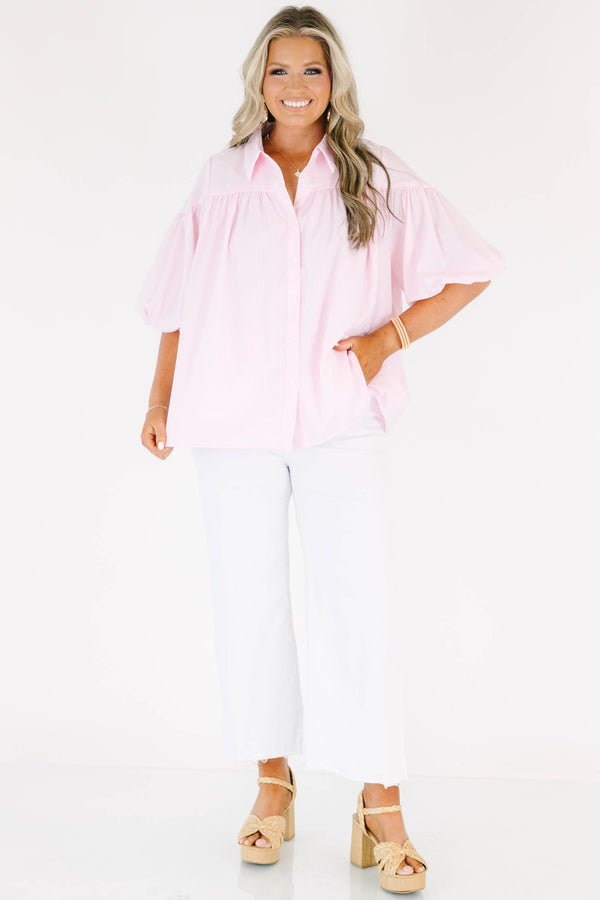 Plus size pink button up blouse with puff sleeves and a flowy fit.
