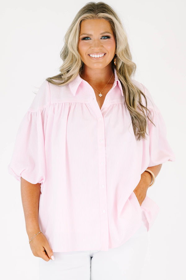 Plus size pink button up blouse with puff sleeves and a flowy fit.