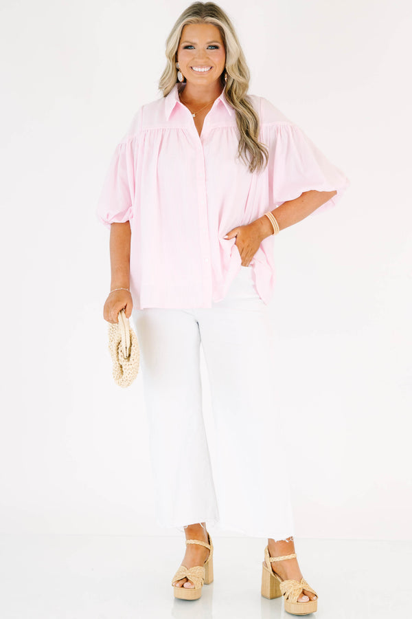 Plus size pink button up blouse with puff sleeves and a flowy fit.