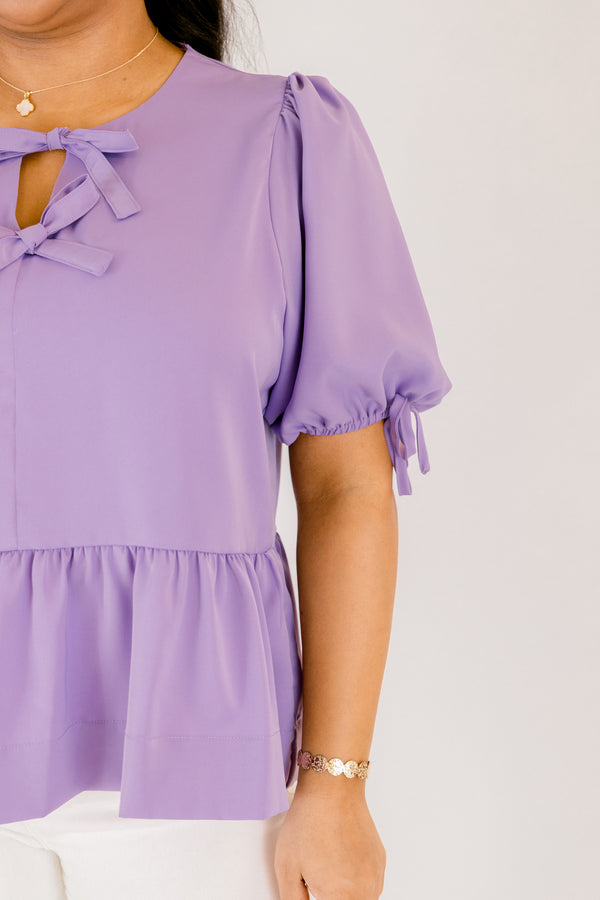 Plus Size purple peplum babydoll top with bow neckline details and elastic puff sleeves.