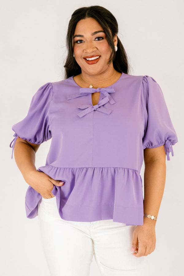 Plus Size purple peplum babydoll top with bow neckline details and elastic puff sleeves.