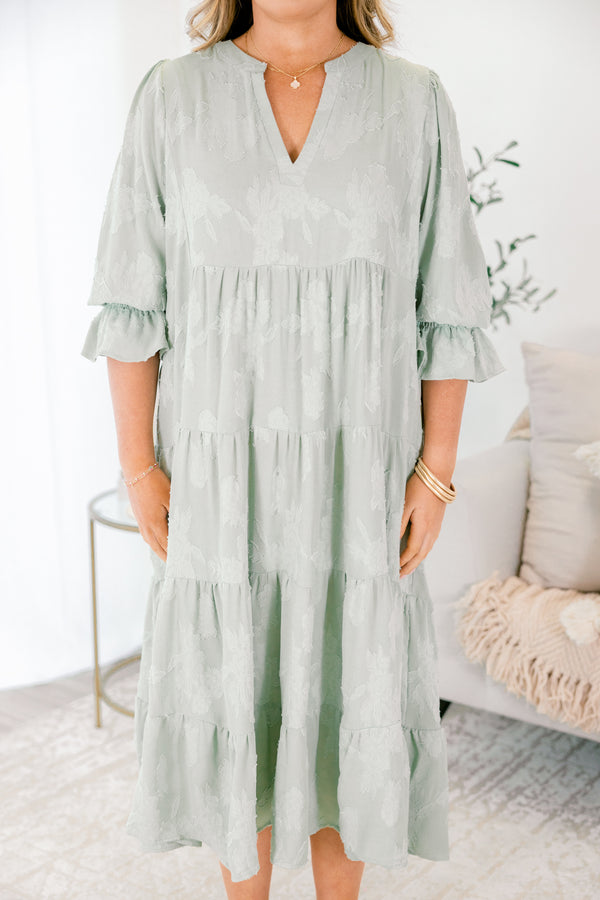 Chic Soul plus size clothing, sage tiered midi dress with half sleeves that have a ruffle detail at the end of each sleeve as well as a subtle floral pattern throughout and a slight v-neckline 
