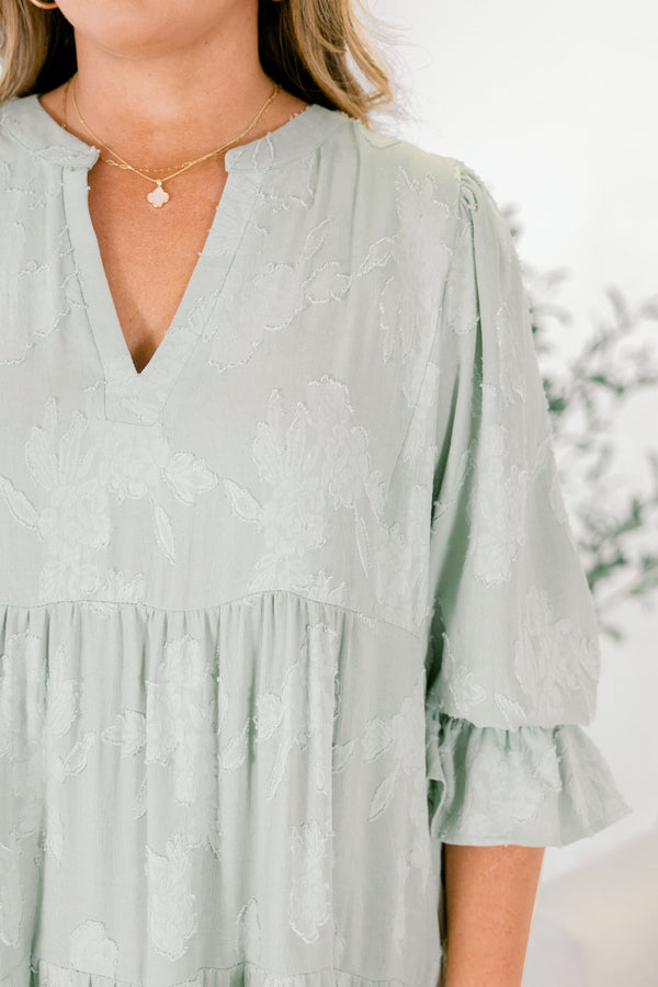 Chic Soul plus size clothing, sage tiered midi dress with half sleeves that have a ruffle detail at the end of each sleeve as well as a subtle floral pattern throughout and a slight v-neckline 
