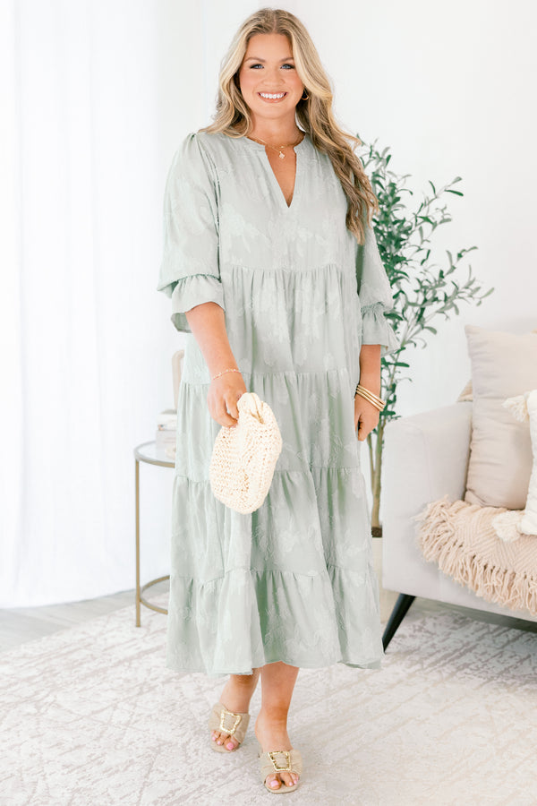 Chic Soul plus size clothing, sage tiered midi dress with half sleeves that have a ruffle detail at the end of each sleeve as well as a subtle floral pattern throughout and a slight v-neckline 
