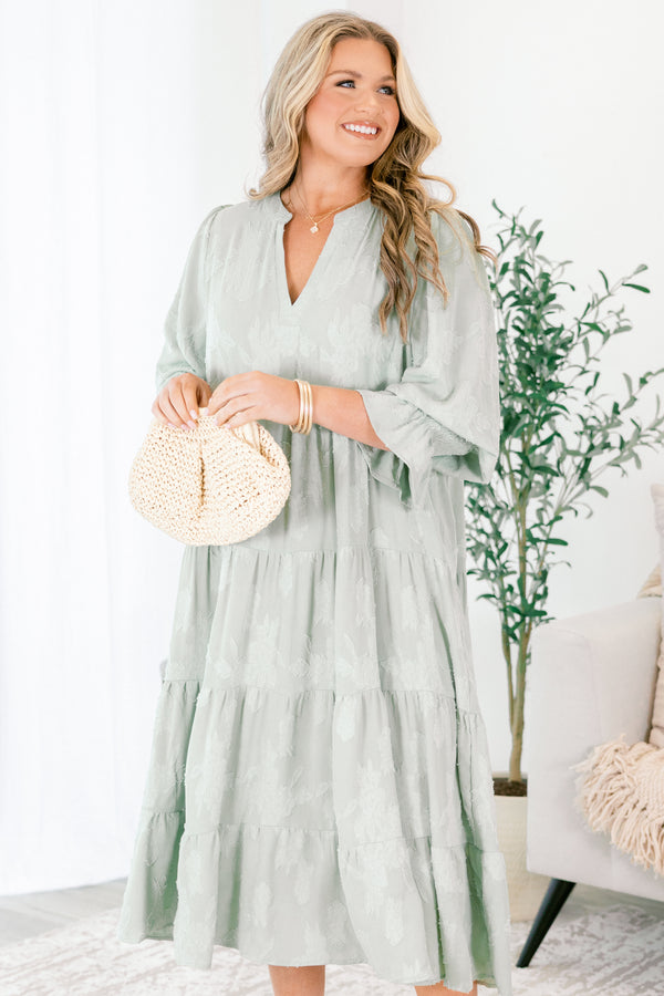 Chic Soul plus size clothing, sage tiered midi dress with half sleeves that have a ruffle detail at the end of each sleeve as well as a subtle floral pattern throughout and a slight v-neckline 
