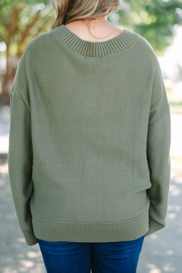 Plus Size olive green v-neck sweater with a relaxed fit, ribbed trim, and long drop-shoulder sleeves.