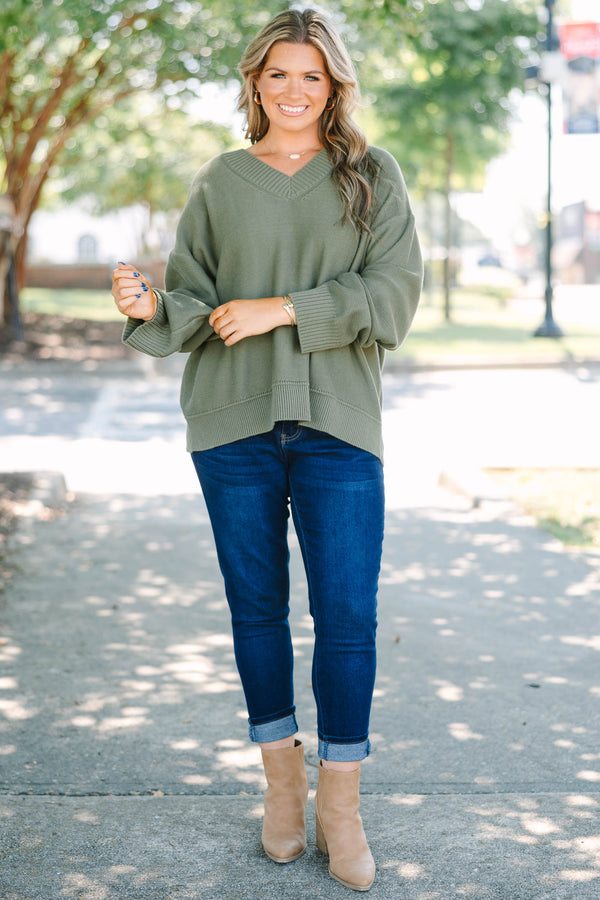 Plus Size olive green v-neck sweater with a relaxed fit, ribbed trim, and long drop-shoulder sleeves.