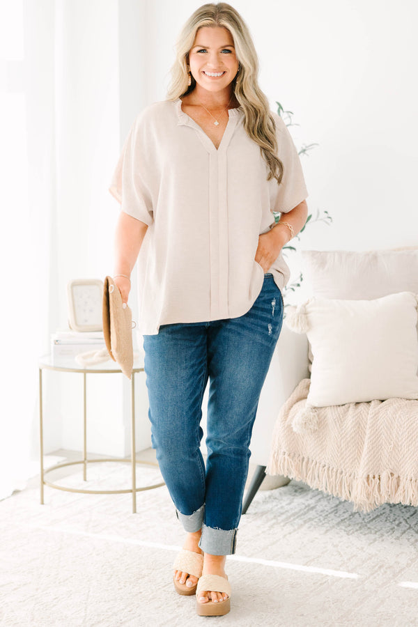 Plus Size dark wash skinny jeans with distressed details and cuffed hems.