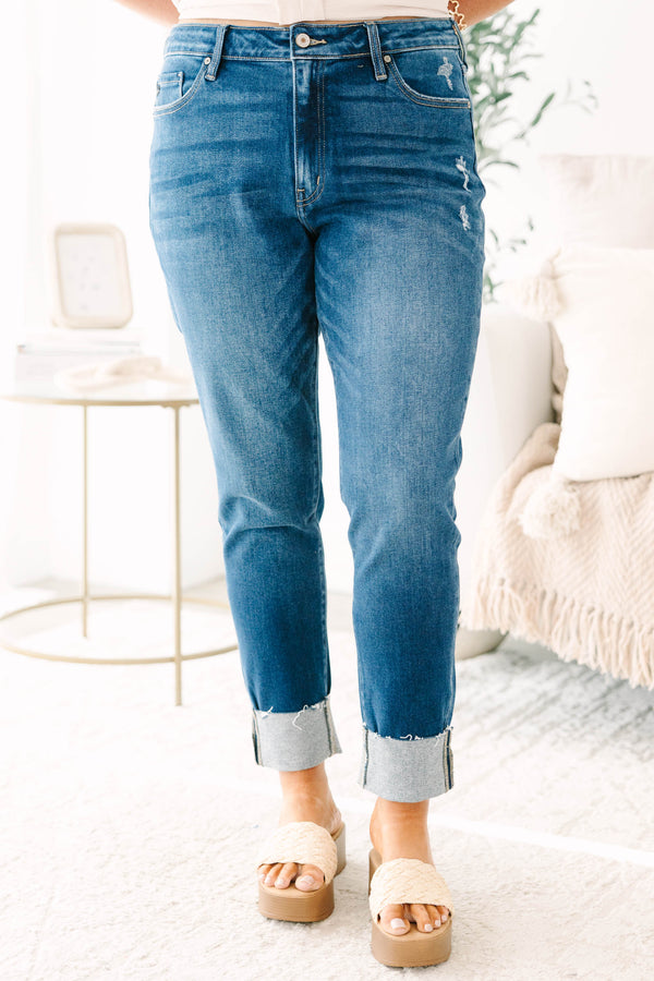 Plus Size dark wash skinny jeans with distressed details and cuffed hems.