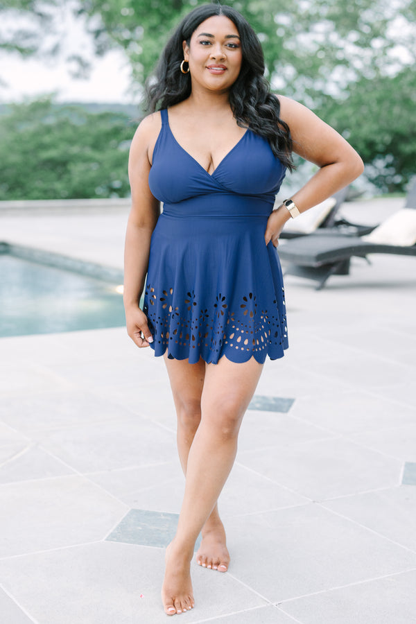 Plus Size navy blue swim dress with a surplice neckline and laser-cut floral hem.