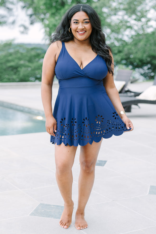 Plus Size navy blue swim dress with a surplice neckline and laser-cut floral hem.
