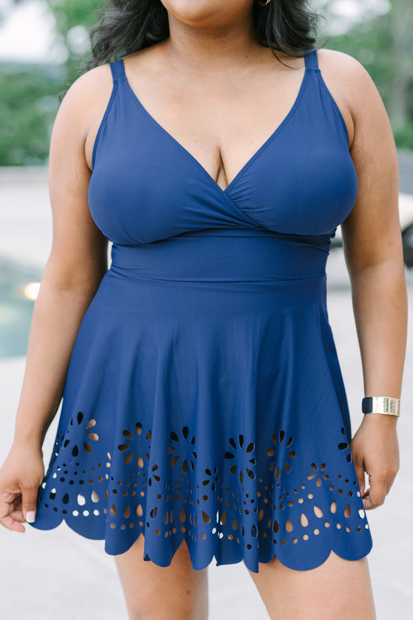 Plus Size navy blue swim dress with a surplice neckline and laser-cut floral hem.