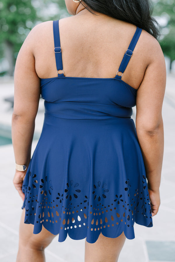 Plus Size navy blue swim dress with a surplice neckline and laser-cut floral hem.