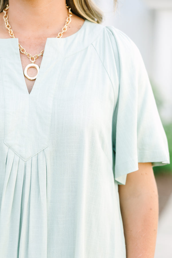 Plus Size sage green short-sleeve dress with a V-neckline and pleated front detailing.