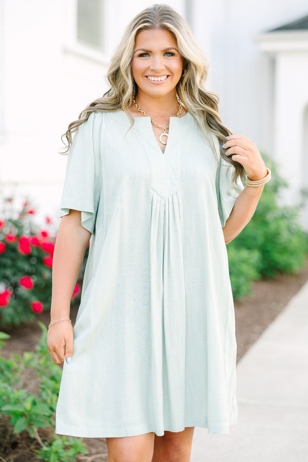 Plus Size sage green short-sleeve dress with a V-neckline and pleated front detailing.