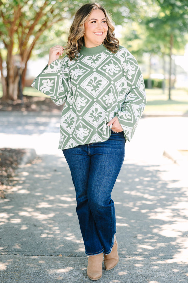 Plus Size green mock-neck sweater with a white diamond and floral-abstract print and wide sleeves.