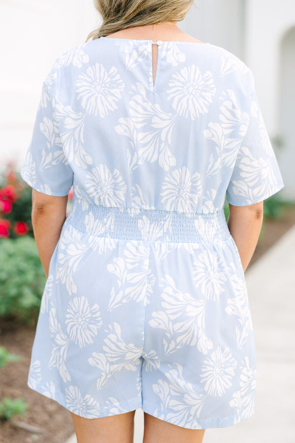 Plus Size baby blue floral romper with a surplice neckline, short sleeves, and elastic waist.