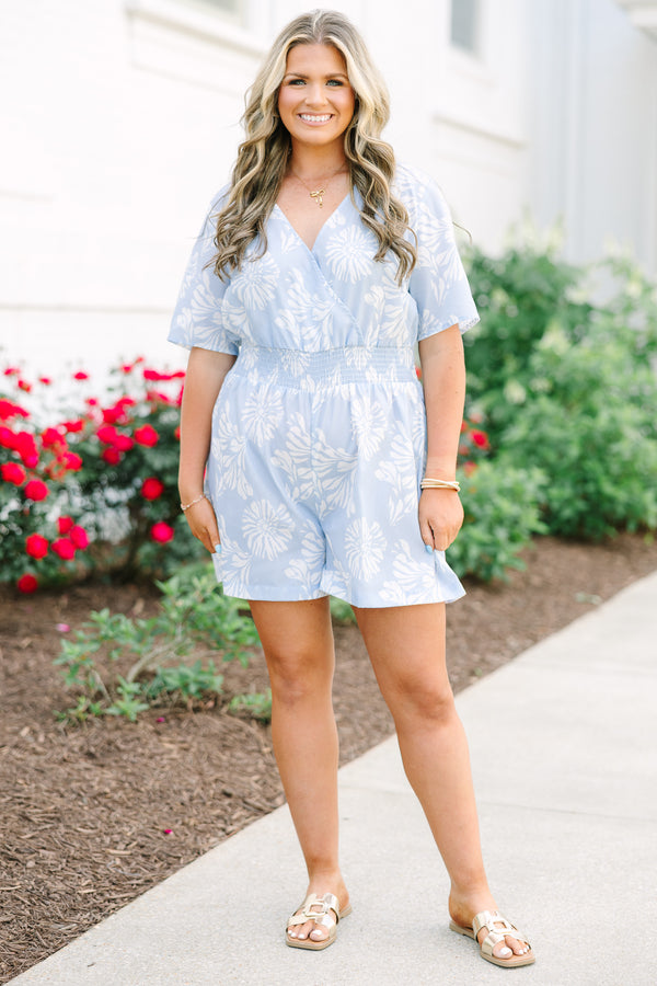 Plus Size baby blue floral romper with a surplice neckline, short sleeves, and elastic waist.
