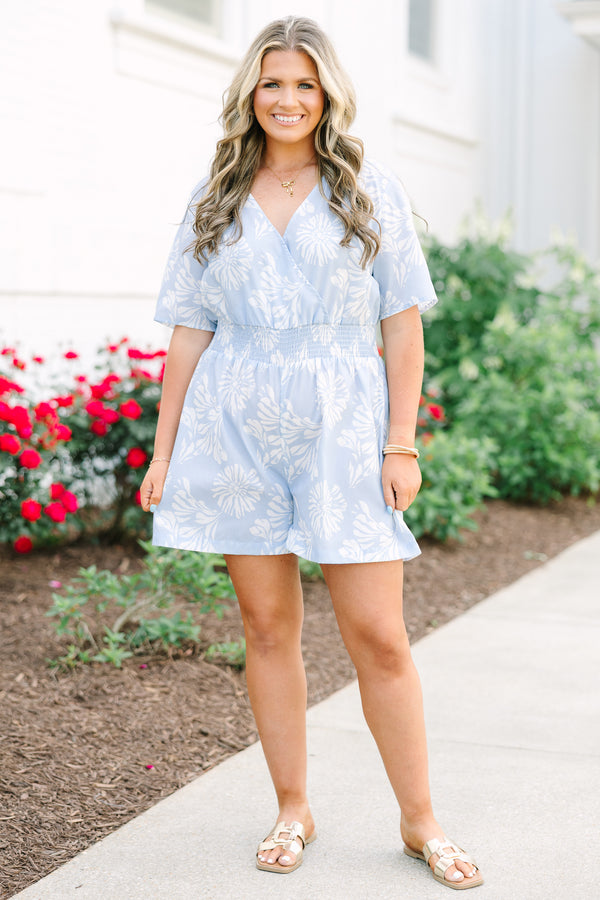 Plus Size baby blue floral romper with a surplice neckline, short sleeves, and elastic waist.
