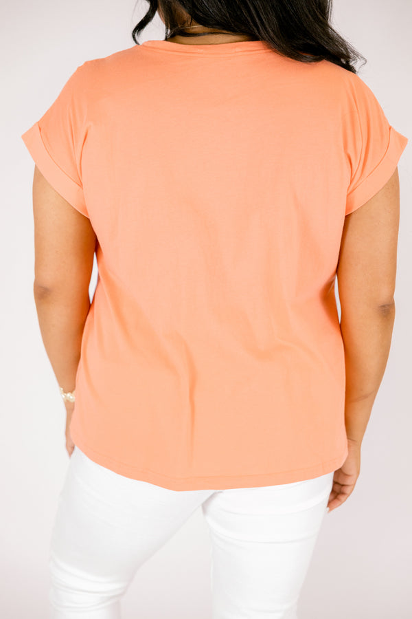 coral tee with cuffed short sleeves and a round neckline