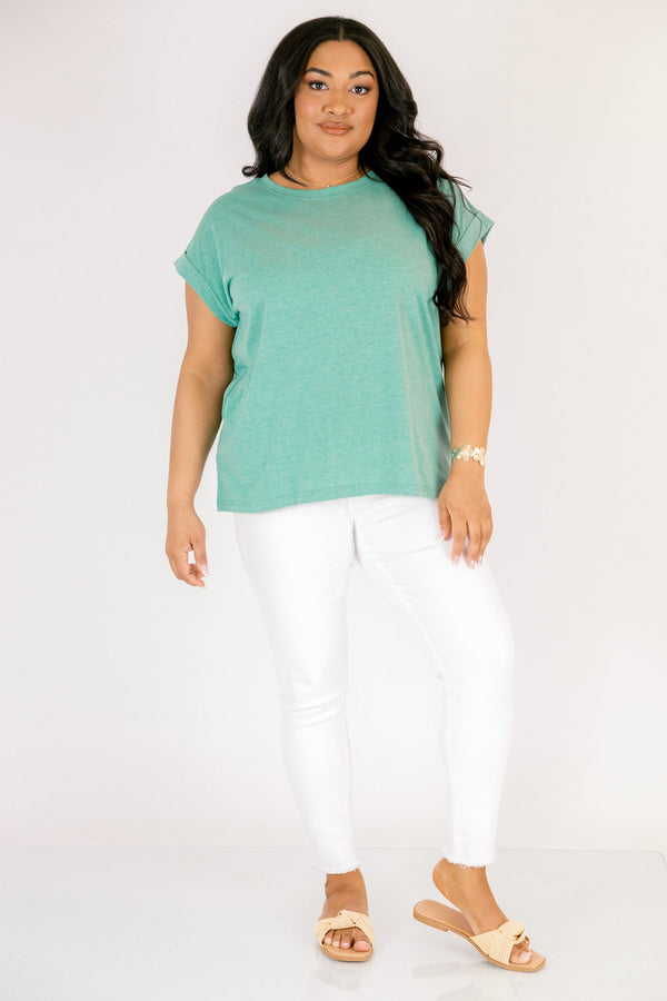 Plus Size heather kelly green crew neck cotton tee with cuffed short sleeves and white pants.