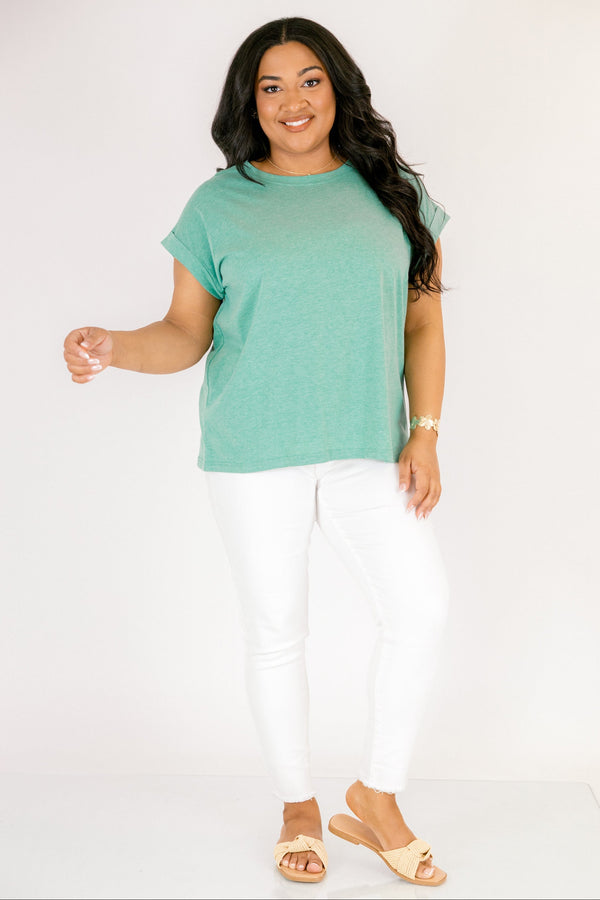 Plus Size heather kelly green crew neck cotton tee with cuffed short sleeves and white pants.