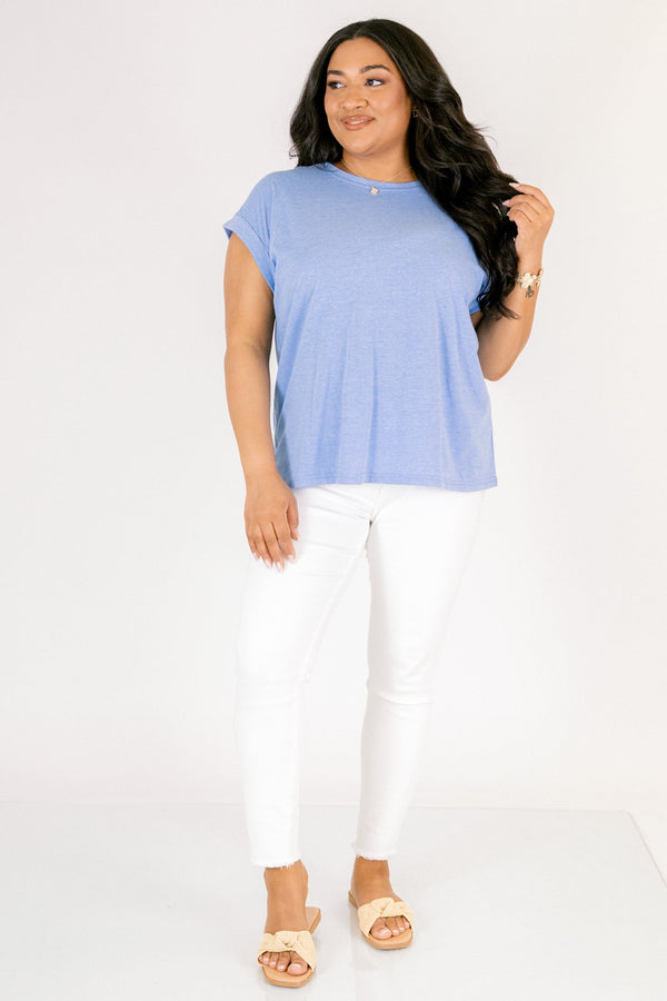 Plus Size heather ocean blue crew neck tee with cuffed short sleeves and white pants.