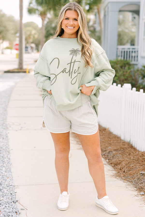 Chic Soul plus size clothing, light tan athletic shorts with a stretchy high waistband as well as a white outlining the bottom of the shorts and up the sides 
