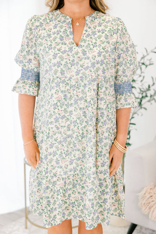 Chic Soul plus size clothing, cream taupe knee length dress with half sleeves that have a ruffle detail at the end of them as well as blue stitching details above the ruffle and a floral pattern throughout the dress 