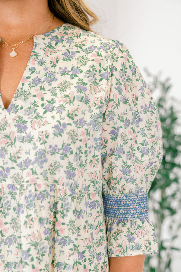 Chic Soul plus size clothing, cream taupe knee length dress with half sleeves that have a ruffle detail at the end of them as well as blue stitching details above the ruffle and a floral pattern throughout the dress 