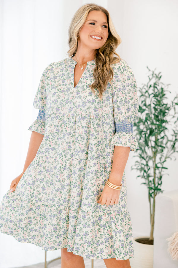 Chic Soul plus size clothing, cream taupe knee length dress with half sleeves that have a ruffle detail at the end of them as well as blue stitching details above the ruffle and a floral pattern throughout the dress 