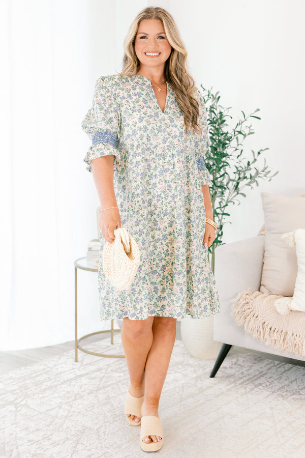 Chic Soul plus size clothing, cream taupe knee length dress with half sleeves that have a ruffle detail at the end of them as well as blue stitching details above the ruffle and a floral pattern throughout the dress 